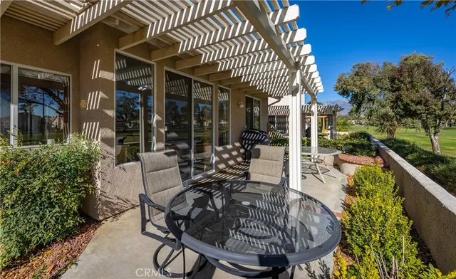 a view of a chairs and table in patio with a barbeque grill