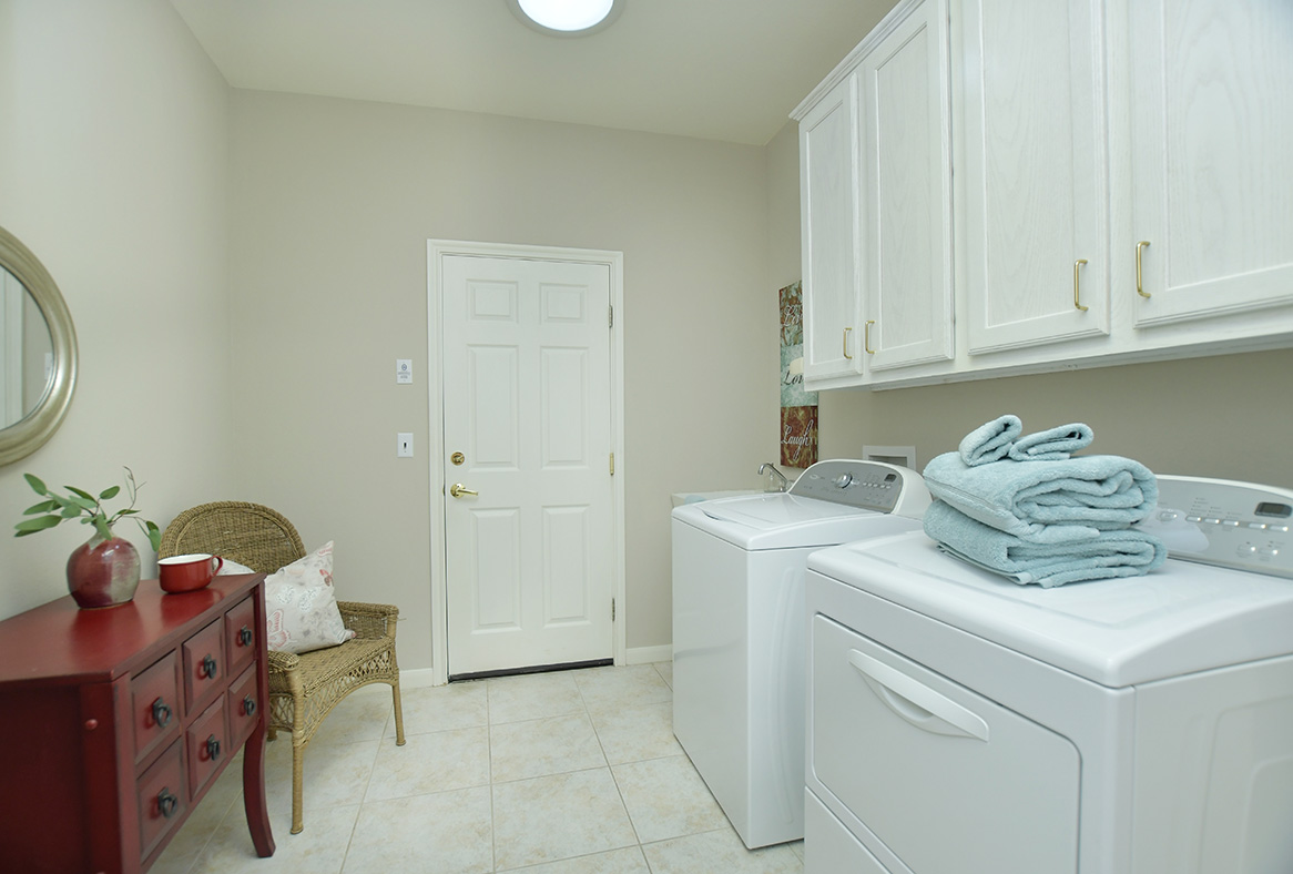 114 Lone Star Drive Georgetown, TX 78633 - Photo 28 of 30 Ample cabinetry above the washer & dryer provides seamless organization, while extra space in this room can be purposed however best suits your needs.