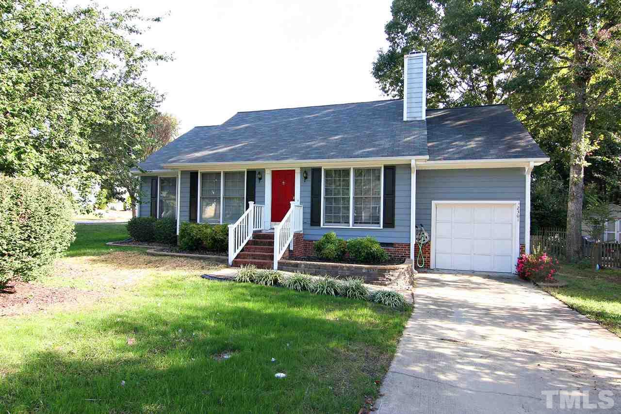 2301 Florida Court Raleigh, NC 27615 - Photo 1 of 20 a front view of a house with a yard and potted plants