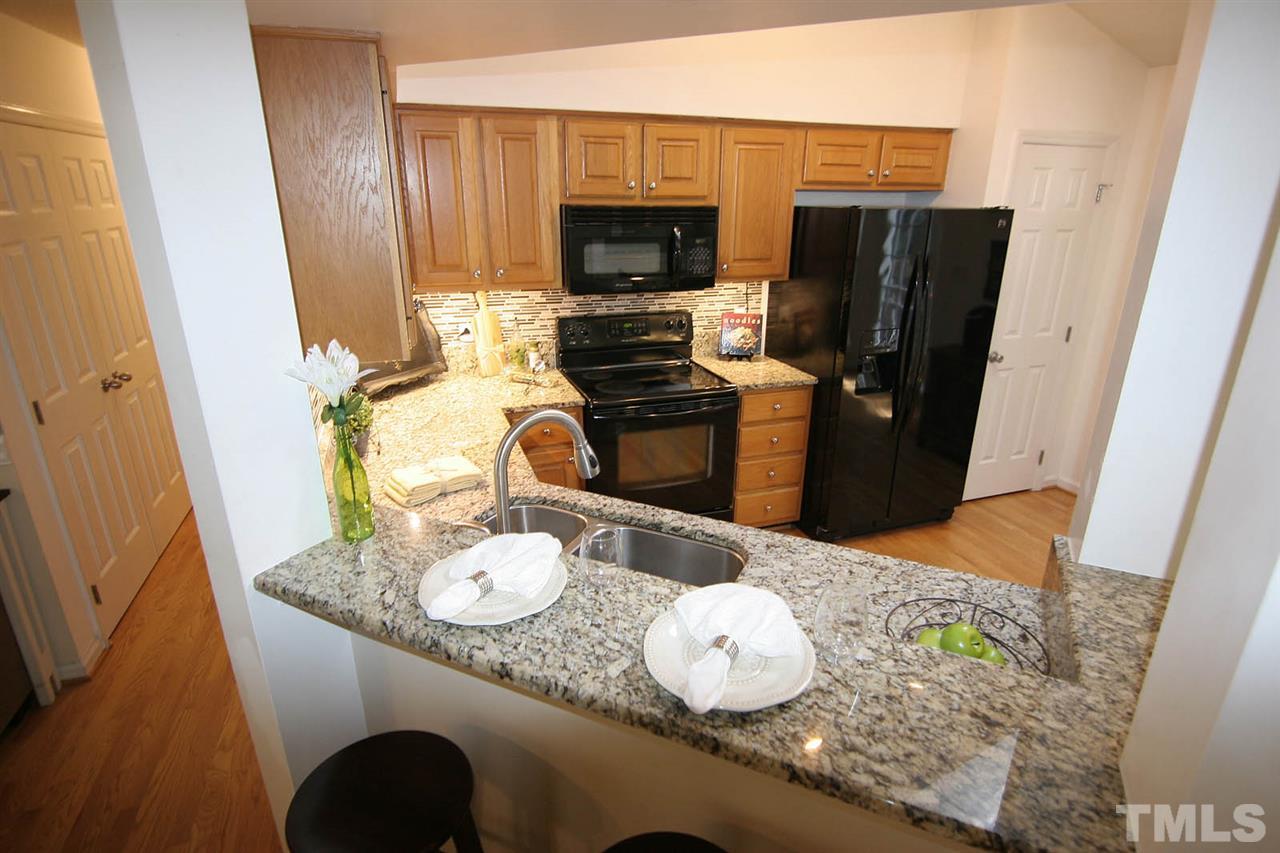2301 Florida Court Raleigh, NC 27615 - Photo 11 of 20 a kitchen with a table and chairs in it