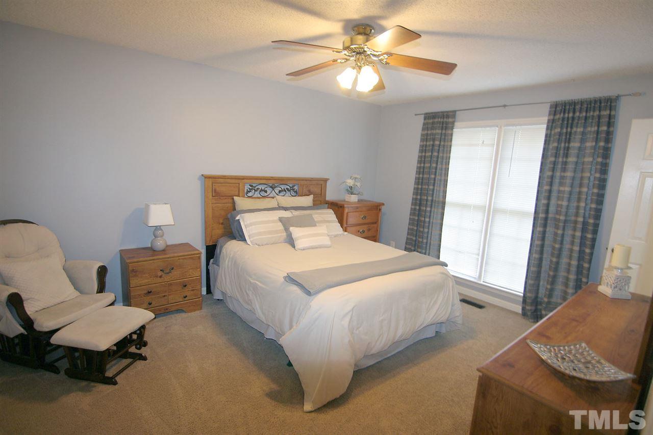2301 Florida Court Raleigh, NC 27615 - Photo 12 of 20 a bedroom with a bed and chair