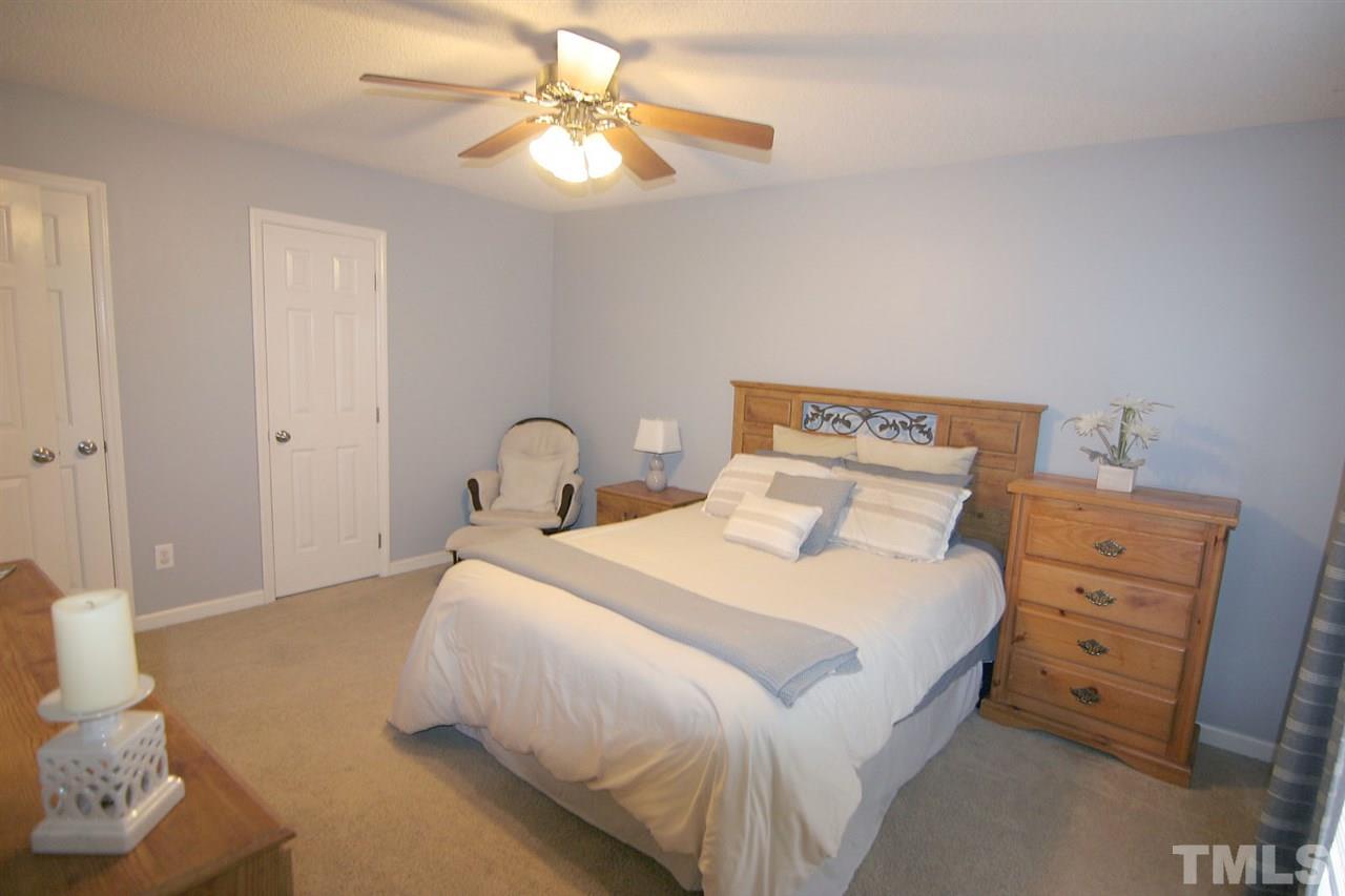 2301 Florida Court Raleigh, NC 27615 - Photo 13 of 20 a bedroom with a bed and a chandelier