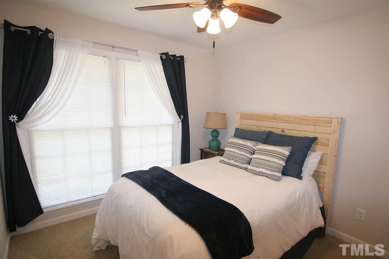 2301 Florida Court Raleigh, NC 27615 - Photo 15 of 20 a bedroom with a bed and a large window