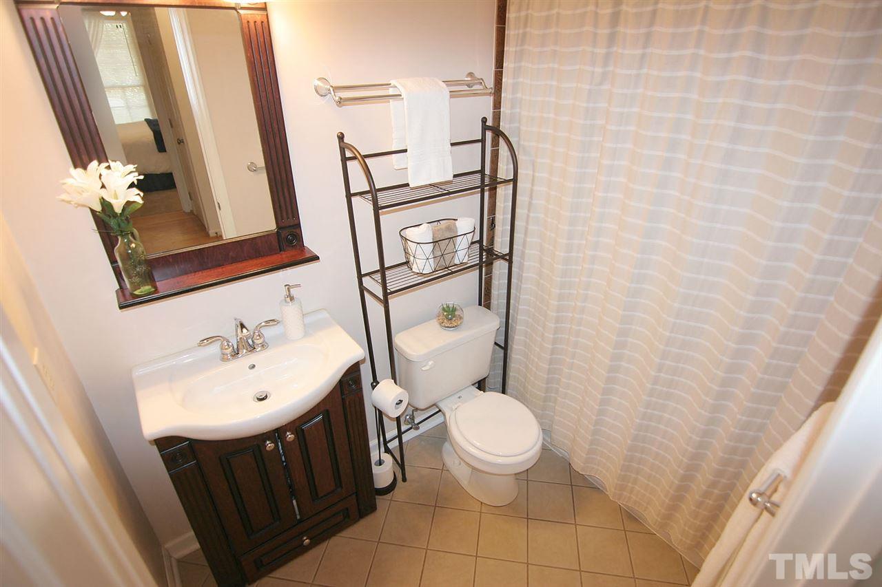 2301 Florida Court Raleigh, NC 27615 - Photo 16 of 20 a bathroom with a sink a toilet and shower