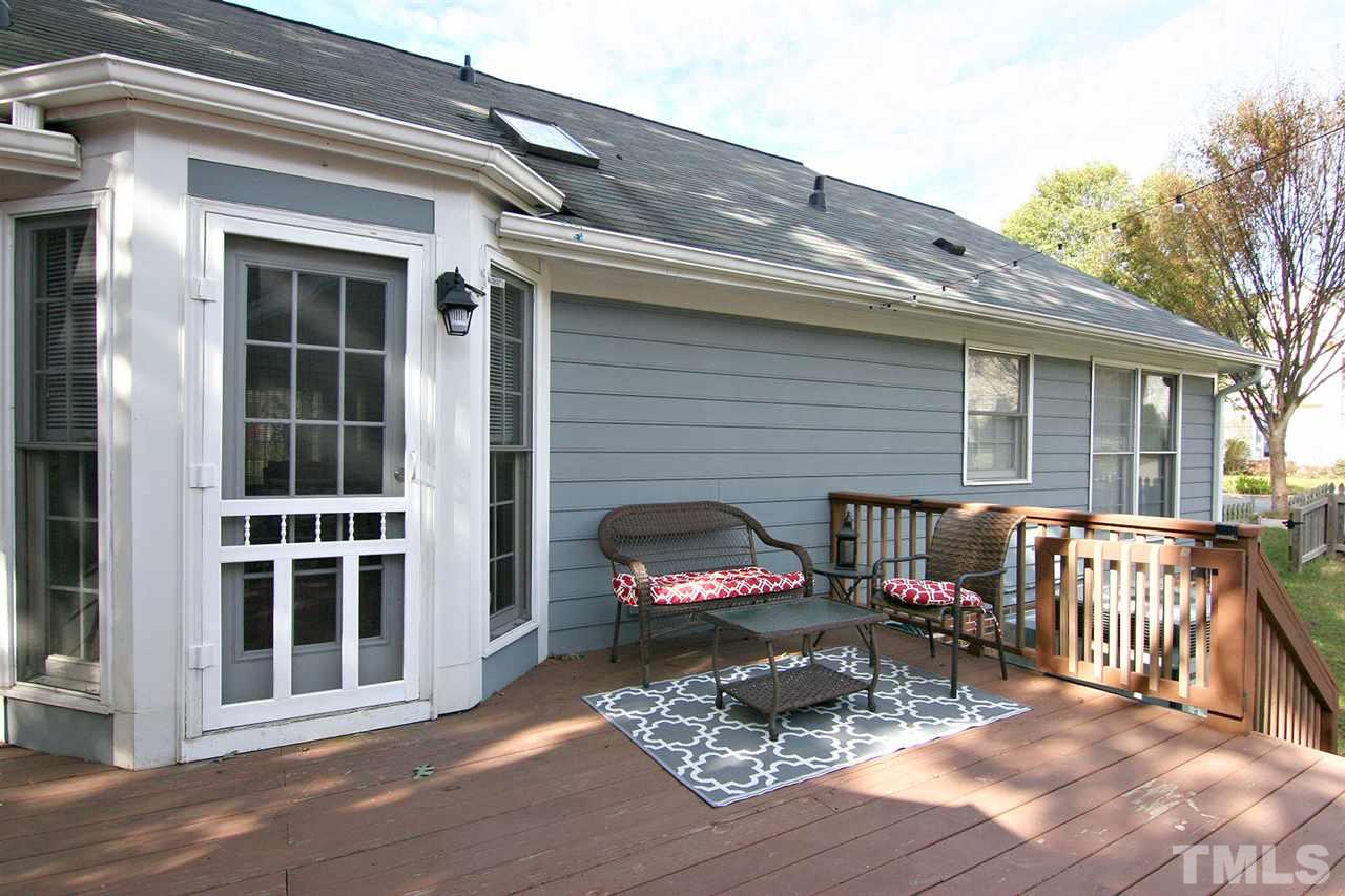 2301 Florida Court Raleigh, NC 27615 - Photo 18 of 20 a view of a patio with a table and chairs and wooden floor