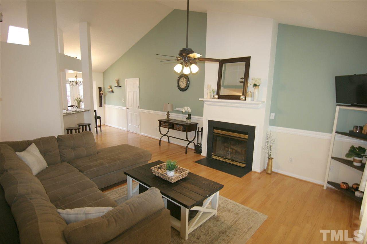 2301 Florida Court Raleigh, NC 27615 - Photo 4 of 20 a living room with furniture a fireplace and a flat screen tv