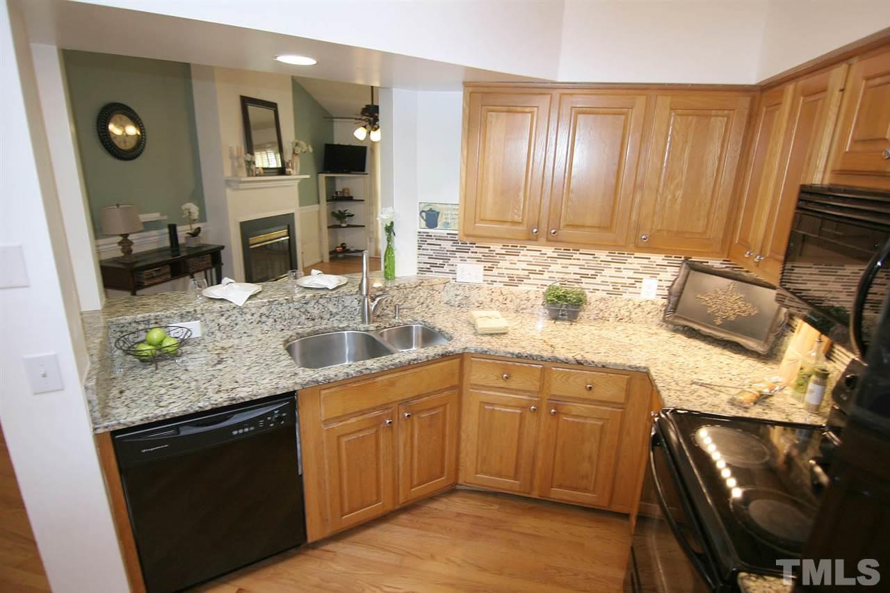 2301 Florida Court Raleigh, NC 27615 - Photo 9 of 20 a kitchen with stainless steel appliances granite countertop a sink stove and cabinets