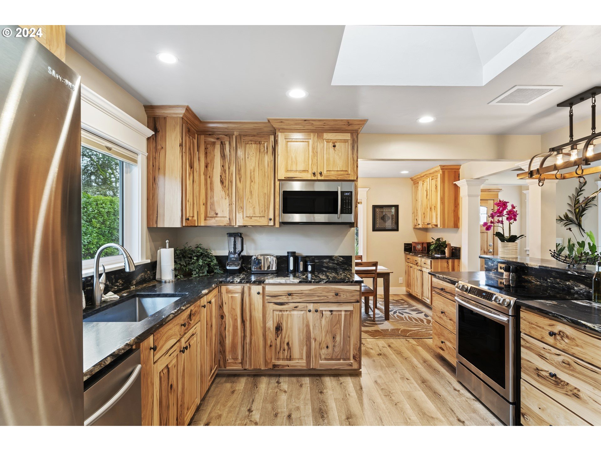 599 River Loop 2 Eugene, OR 97404 - Photo 11 of 25 a kitchen with stainless steel appliances a sink stove and large window