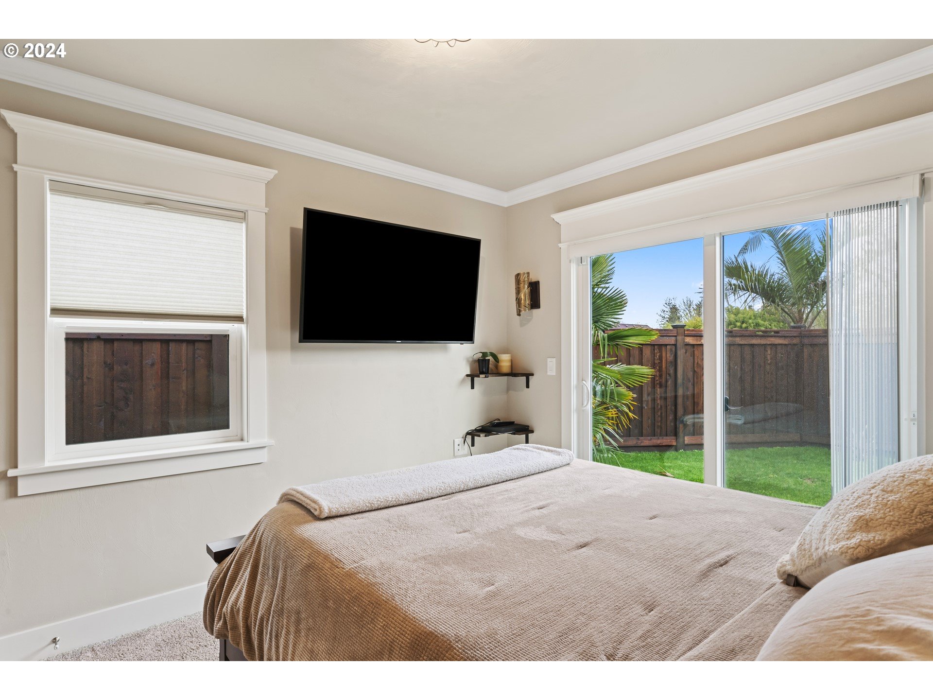 599 River Loop 2 Eugene, OR 97404 - Photo 15 of 25 a bedroom with a bed and a flat screen tv