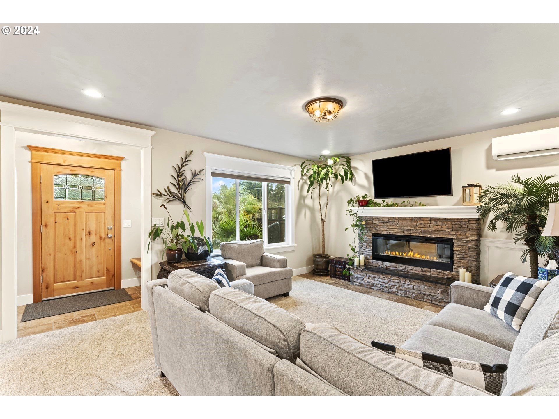 599 River Loop 2 Eugene, OR 97404 - Photo 4 of 25 a living room with furniture a fireplace and a flat screen tv