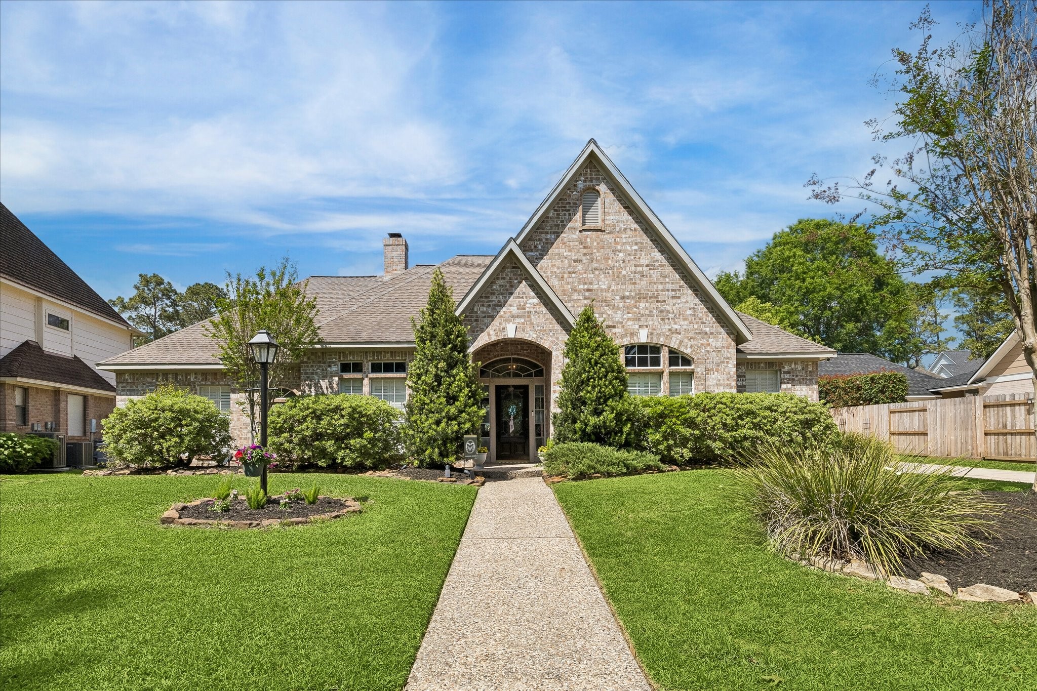 2810 Timber Country Way Kingwood, TX 77345 - Photo 1 of 30 a front view of a house with a yard and potted plants