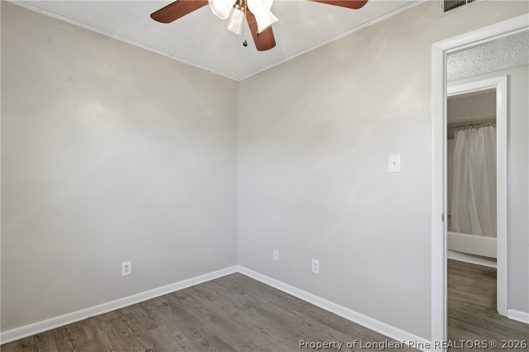 6319 Rustic Ridge Hope Mills, NC 28348 - Photo 26 of 39 an empty room with a chandelier fan and a chandelier fan