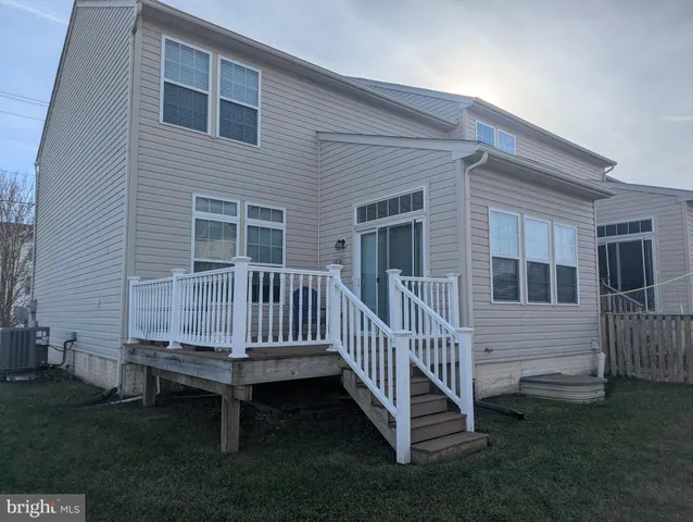 a view of a house with a yard and deck