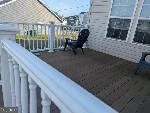 a view of deck with table and chairs