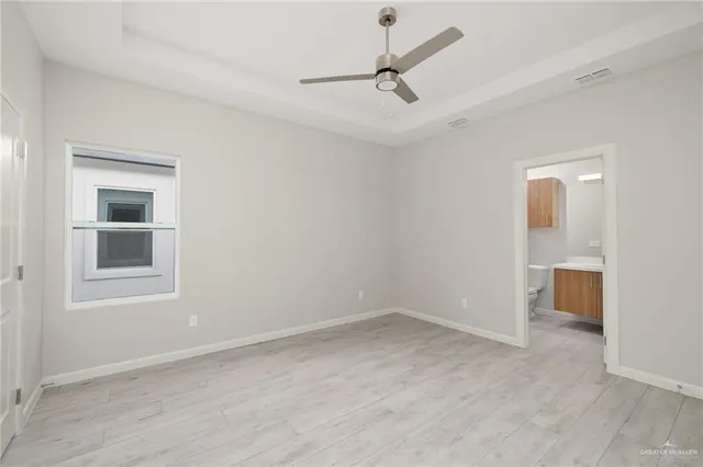 a view of a livingroom with a ceiling fan and window