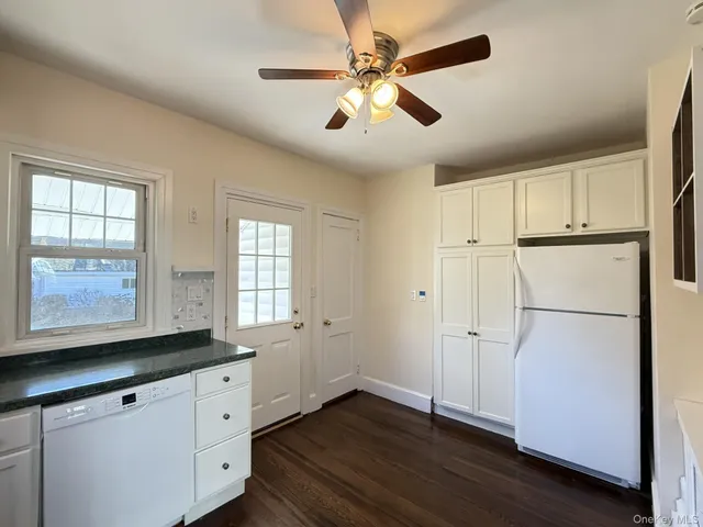 a kitchen with a refrigerator a sink and cabinets