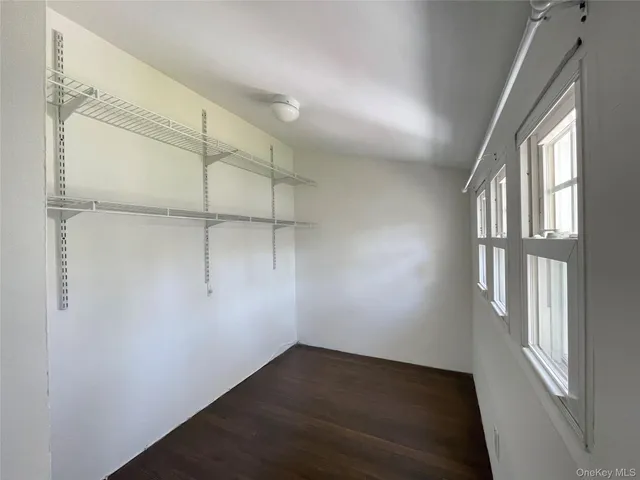 an empty room with a empty space and windows