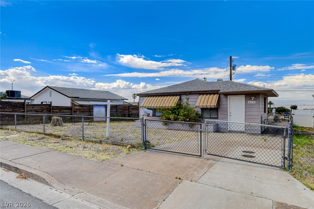 214 West Victory Road Henderson, NV 89015 - Photo 28 of 33 A modest dwelling featuring awnings and a gated entry.