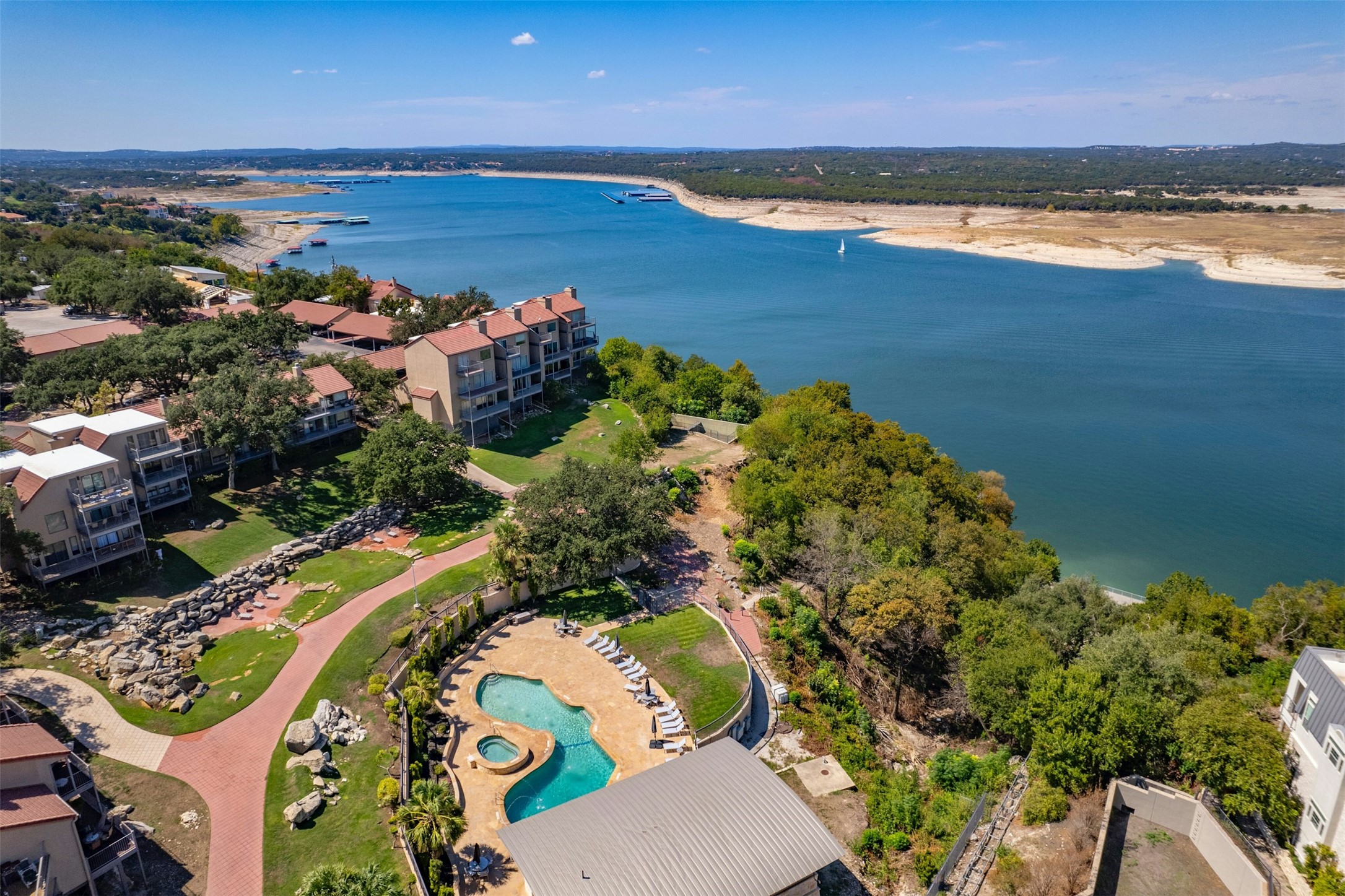 2918 Ranch To Market Road 620, Unit W219 Austin, TX 78734 - Photo 34 of 35 Another stunning aerial capturing the community's layout and direct access to Lake Travis - perfect for boating, paddleboarding, and sunset watching.