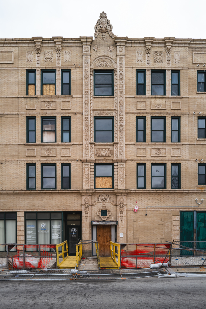 a front view of a residential apartment building with a yard