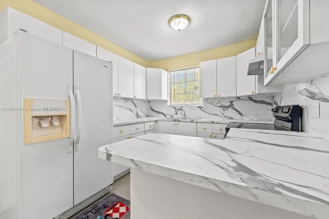 a kitchen with stainless steel appliances sinks a stove and a refrigerator