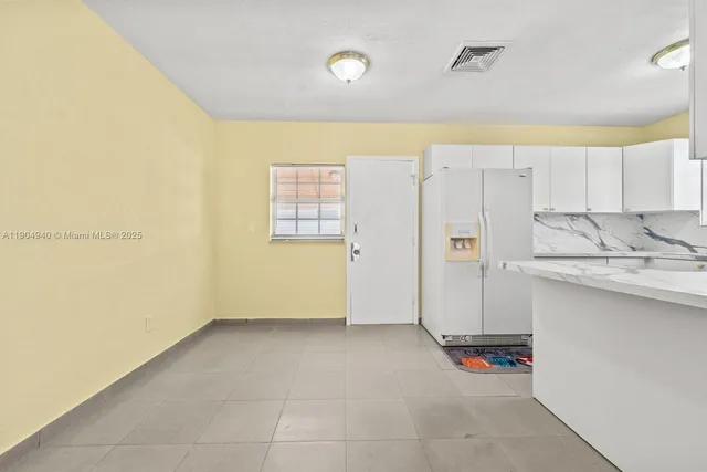 a view of utility room with cabinets