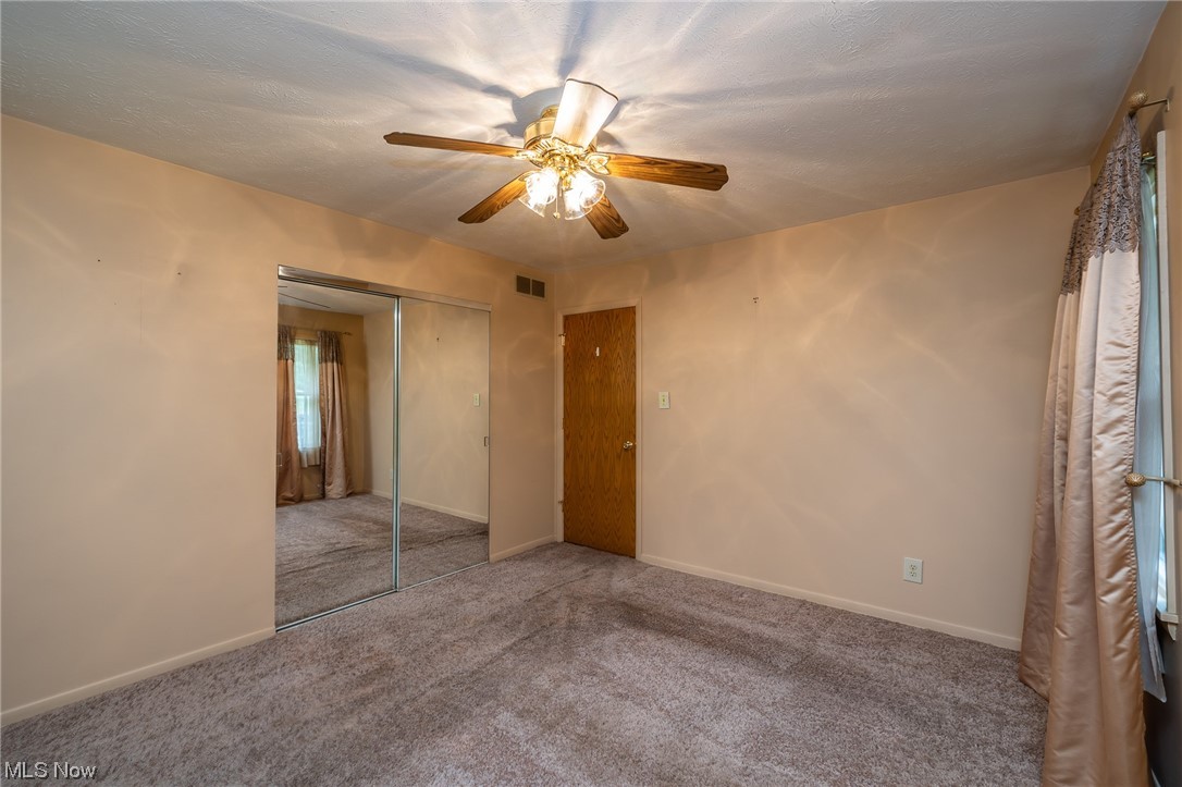 14179 Drake Road Strongsville, OH 44136 - Photo 15 of 33 Unfurnished bedroom featuring carpet, a closet, and ceiling fan