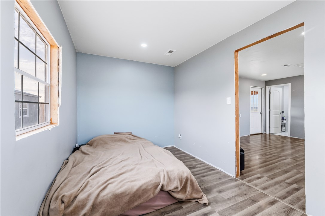 12241 South Robles Road Yucca, AZ 86438 - Photo 14 of 43 Bedroom with wood finished floors and recessed lighting