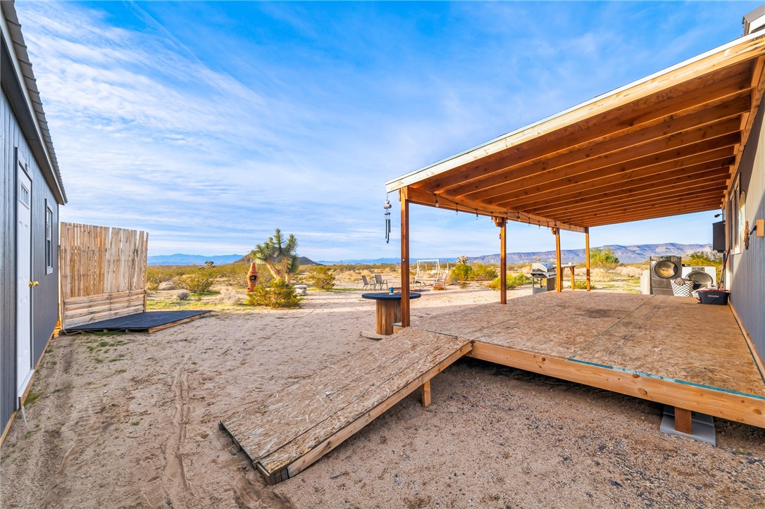 12241 South Robles Road Yucca, AZ 86438 - Photo 21 of 43 View of yard with a deck with mountain view