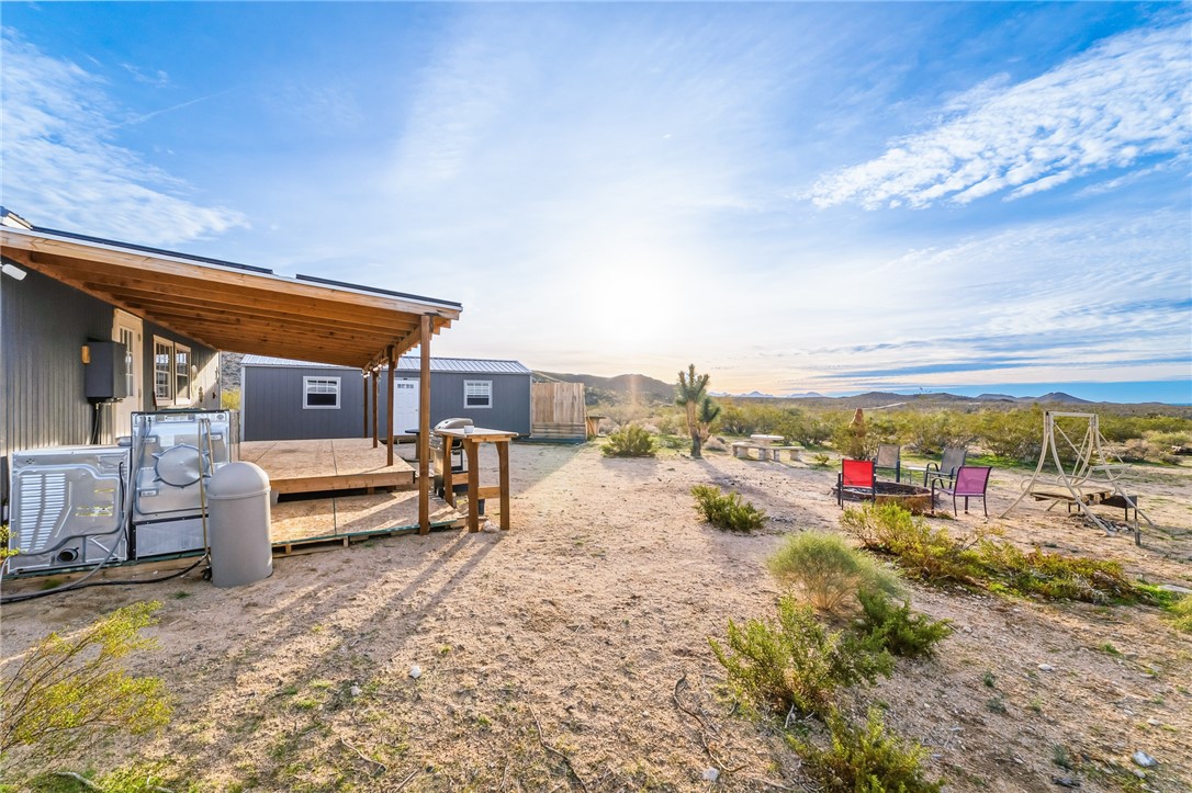 12241 South Robles Road Yucca, AZ 86438 - Photo 23 of 43 View of yard with a deck with mountain view