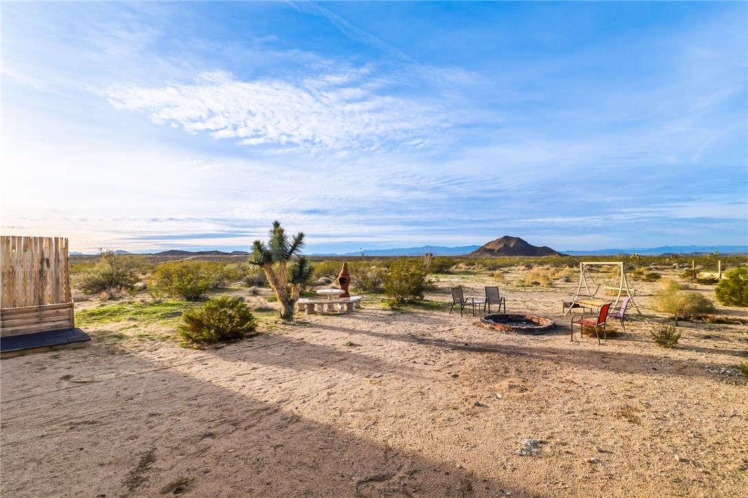 12241 South Robles Road Yucca, AZ 86438 - Photo 25 of 43 View of yard featuring a fire pit, a mountain view, and a rural view