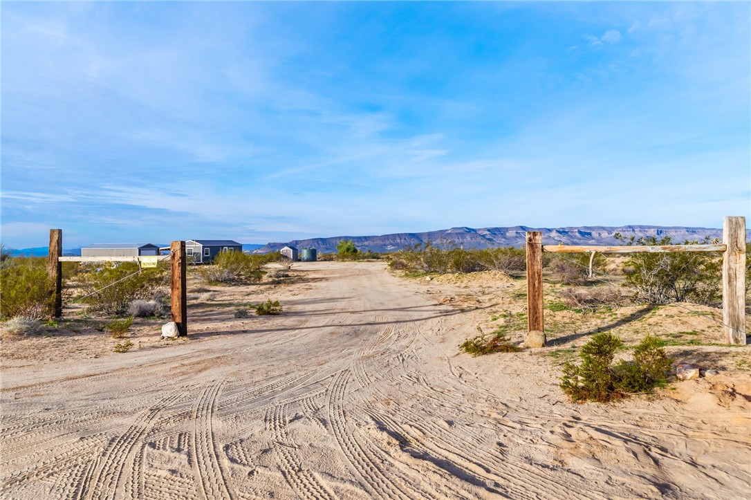 12241 South Robles Road Yucca, AZ 86438 - Photo 32 of 43 View of street featuring a rural view and a mountain view