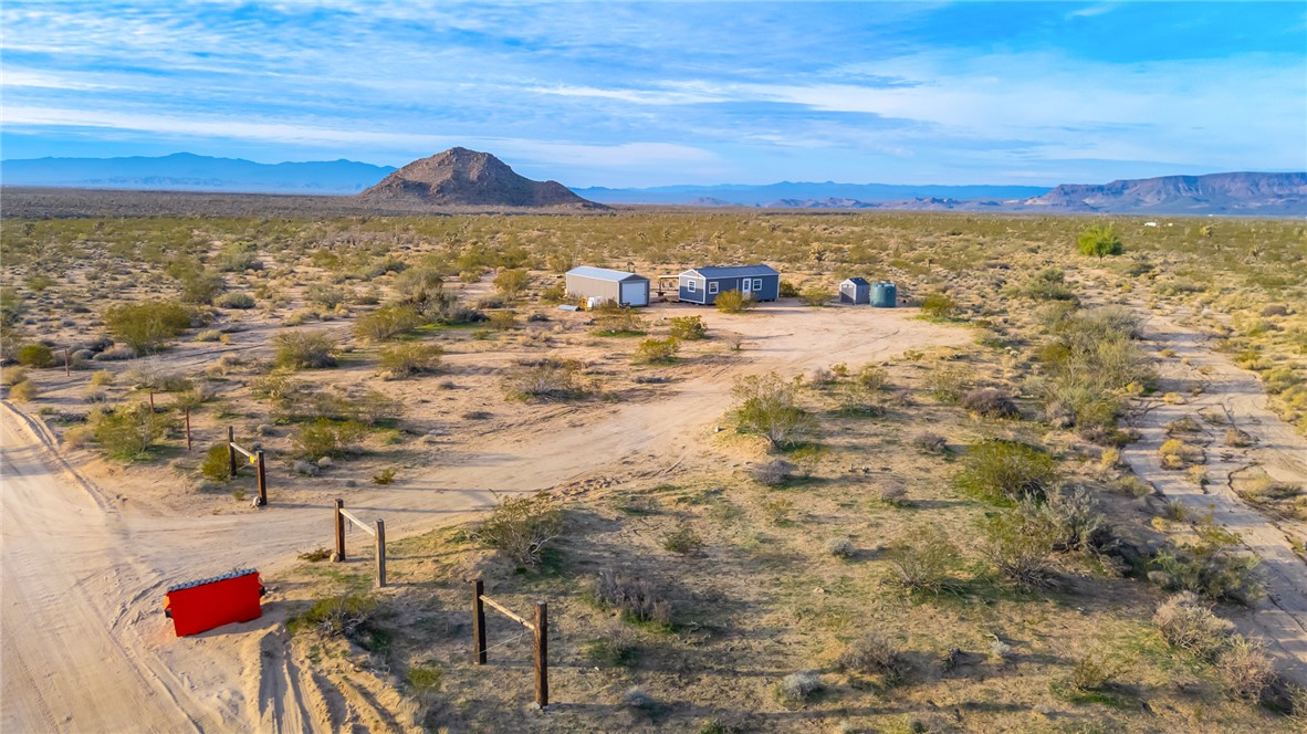 12241 South Robles Road Yucca, AZ 86438 - Photo 33 of 43 Aerial view of sparsely populated area with a mountainous background