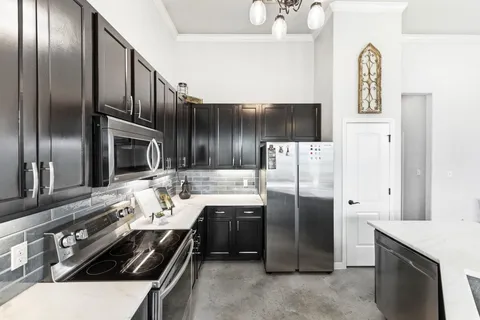 a kitchen with stainless steel appliances a refrigerator sink and stove