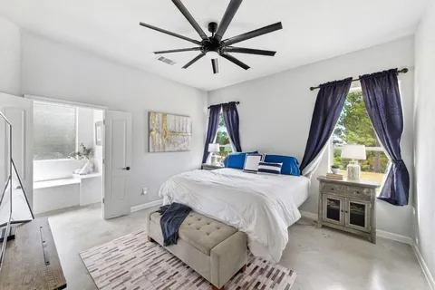 a bedroom with a large bed and a window