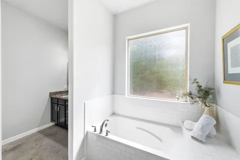 a bathroom with a bathtub and a shower