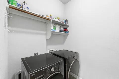 a close up of a utility room with dryer and washer