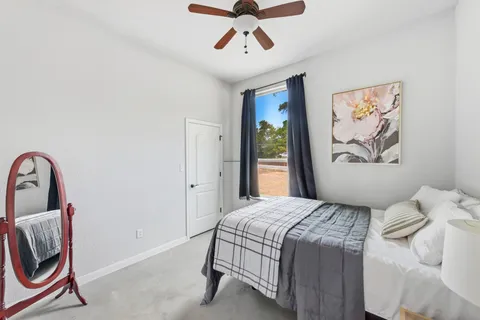a bedroom with a bed and a painting on the wall