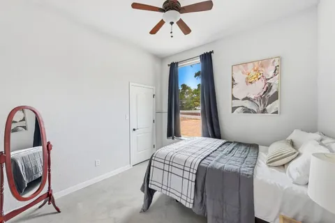 a bedroom with a bed and a painting on the wall