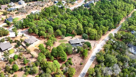 an aerial view of a houses with a yard