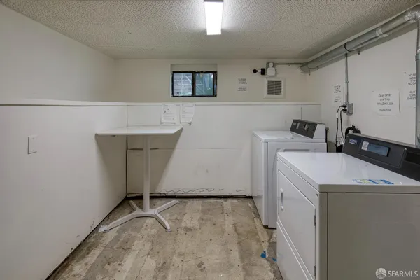 a view of storage and utility room with two washing machine