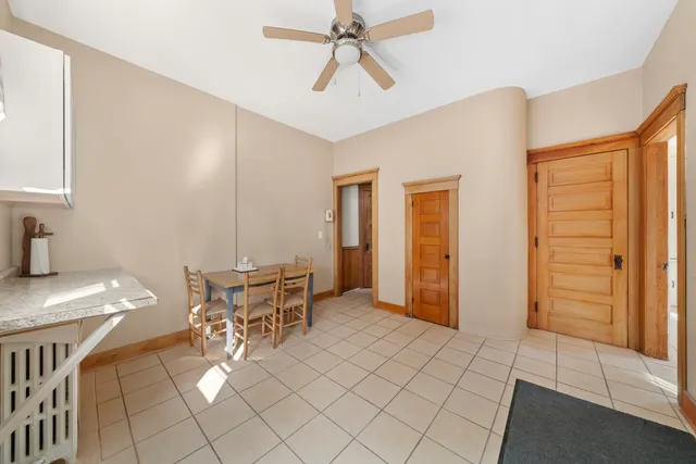 a kitchen with a table chairs and a window
