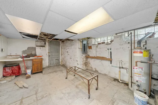 a bathroom with a granite countertop sink a mirror and a toilet