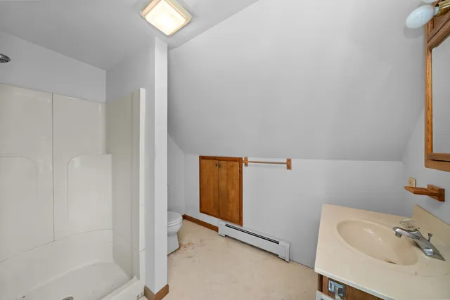 a view of a big room with wooden floor and windows