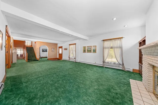 a view of a bedroom with windows and backyard