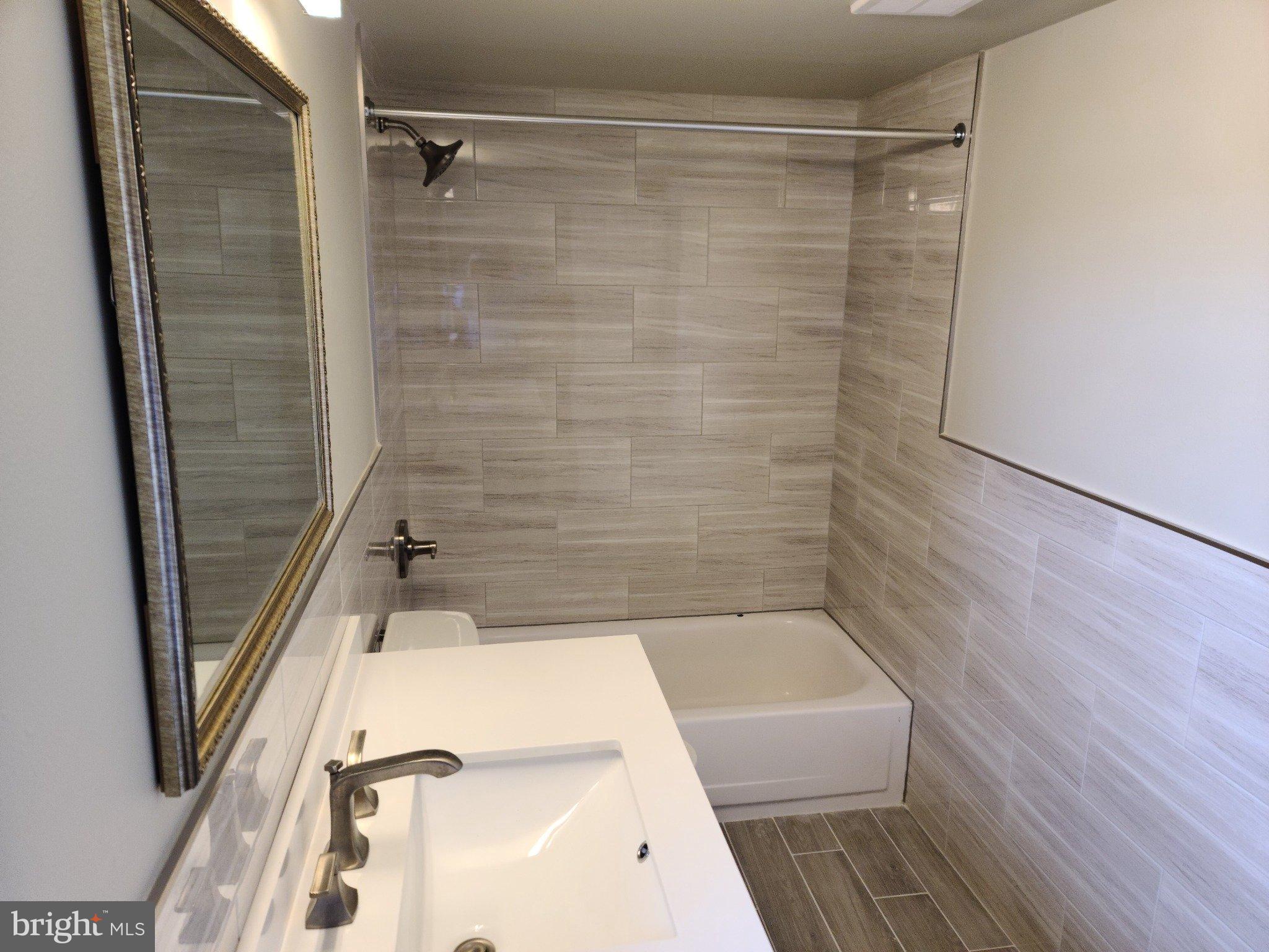 47 Garden View Terrace, Unit 4 East Windsor, NJ 08520 - Photo 3 of 12 a bathroom with a tub and shower