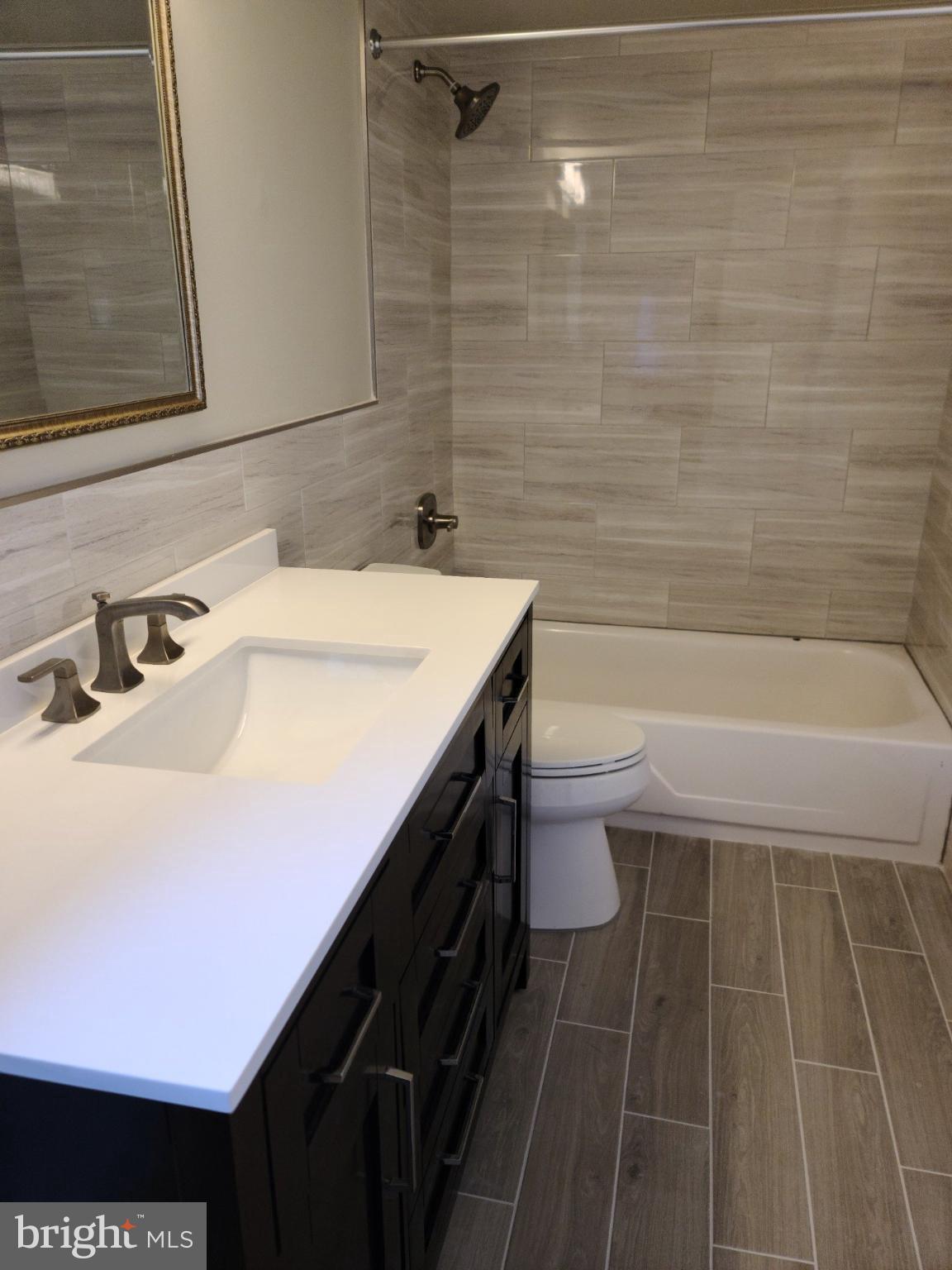 47 Garden View Terrace, Unit 4 East Windsor, NJ 08520 - Photo 9 of 12 a bathroom with a sink a toilet and shower