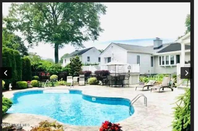 a swimming pool view with a outdoor seating