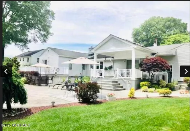 a front view of house with yard and swimming pool