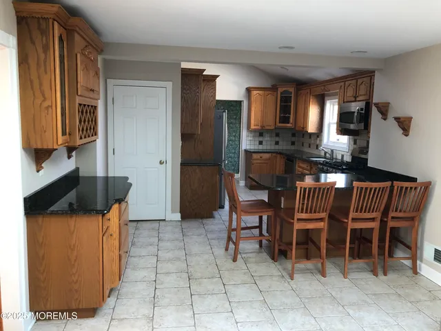a dining room with furniture and a window